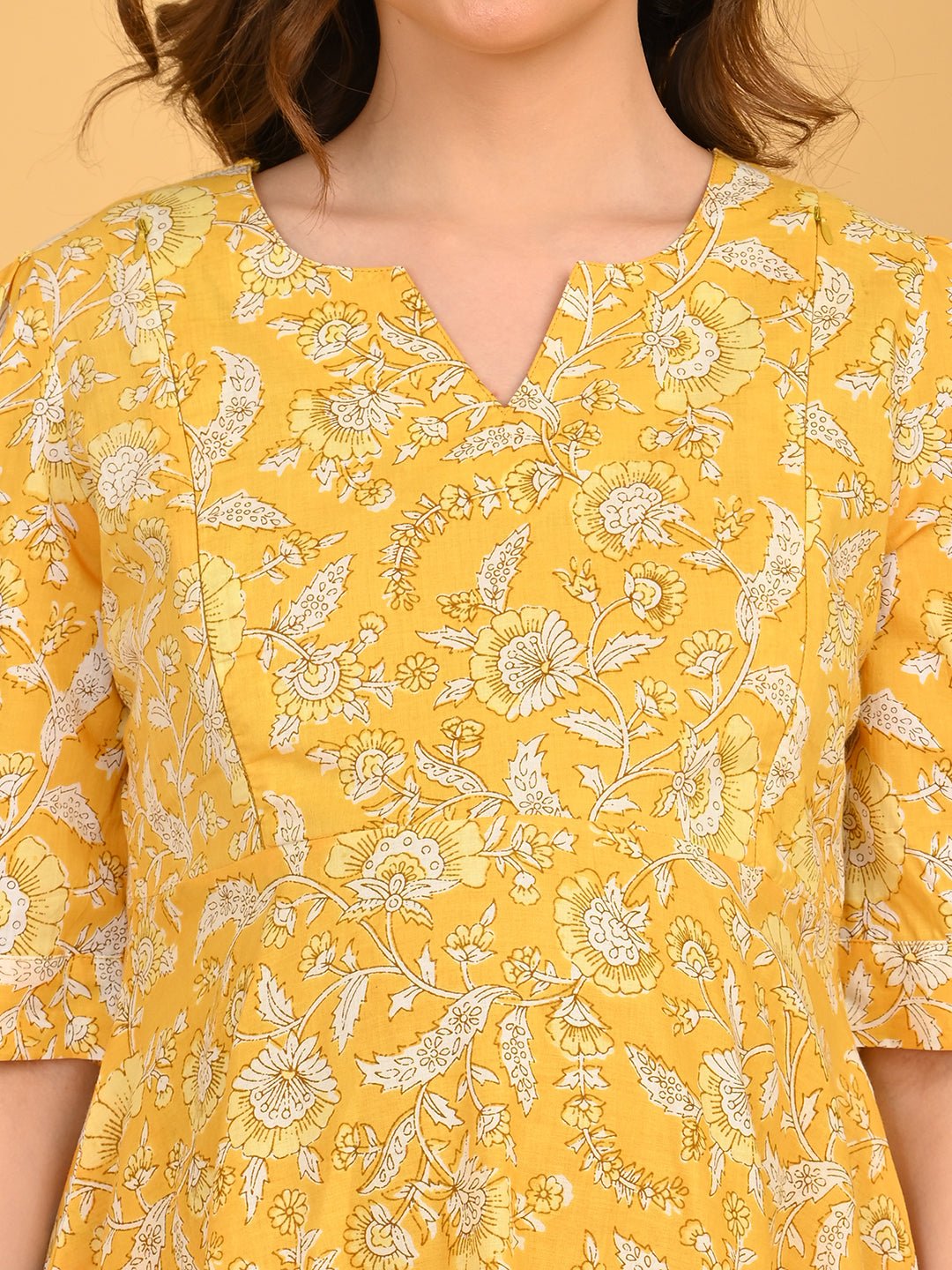 Close-up of yellow floral maternity kurta neckline with subtle V-notch detail.