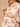Woman wearing a floral dress with a beige background