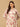 Woman wearing a floral dress against a beige background