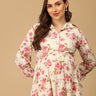 Woman wearing a floral dress against a beige background