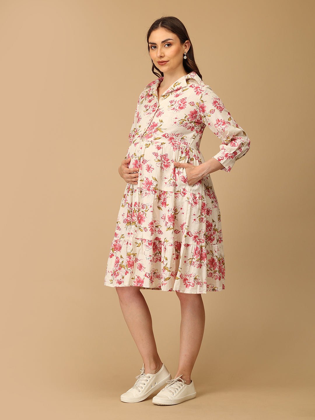 Woman wearing a floral dress on a beige background