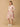 Woman wearing a floral dress on a beige background