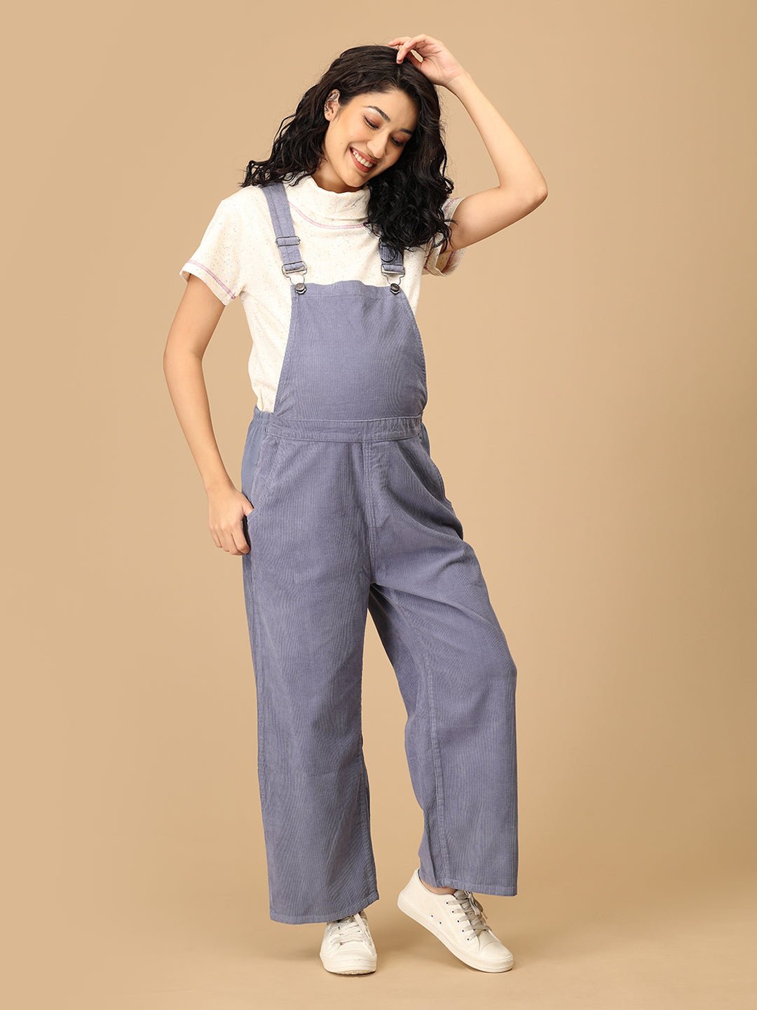 Pregnant woman in The Mom Store powder blue maternity dungaree with adjustable straps front view.