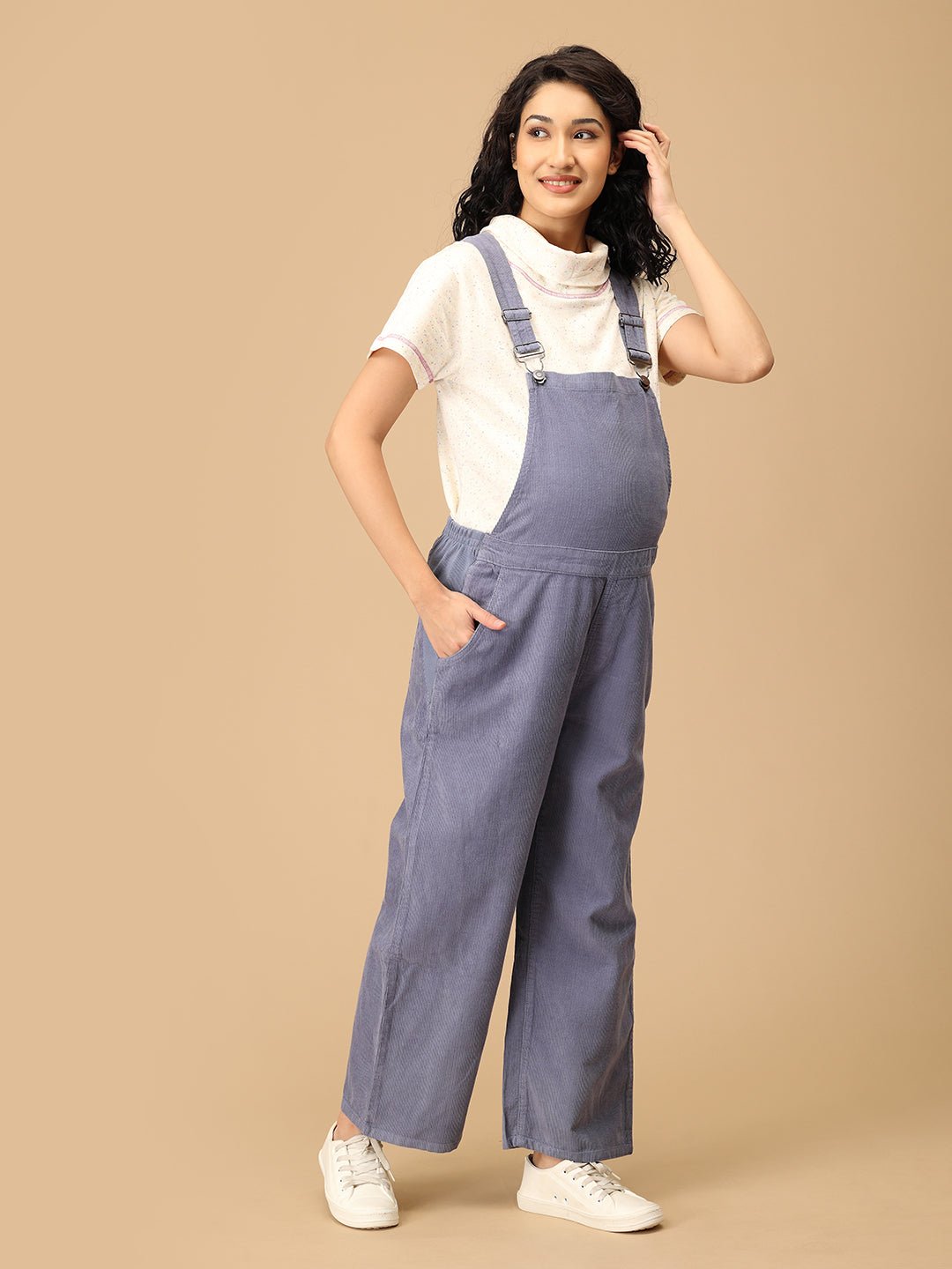 Side angle of The Mom Store powder blue corduroy maternity dungaree with bump-friendly design.
