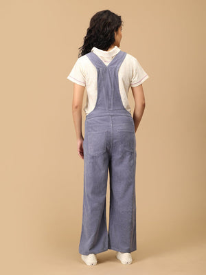 Back view of The Mom Store powder blue corduroy maternity dungaree with cross-back straps.