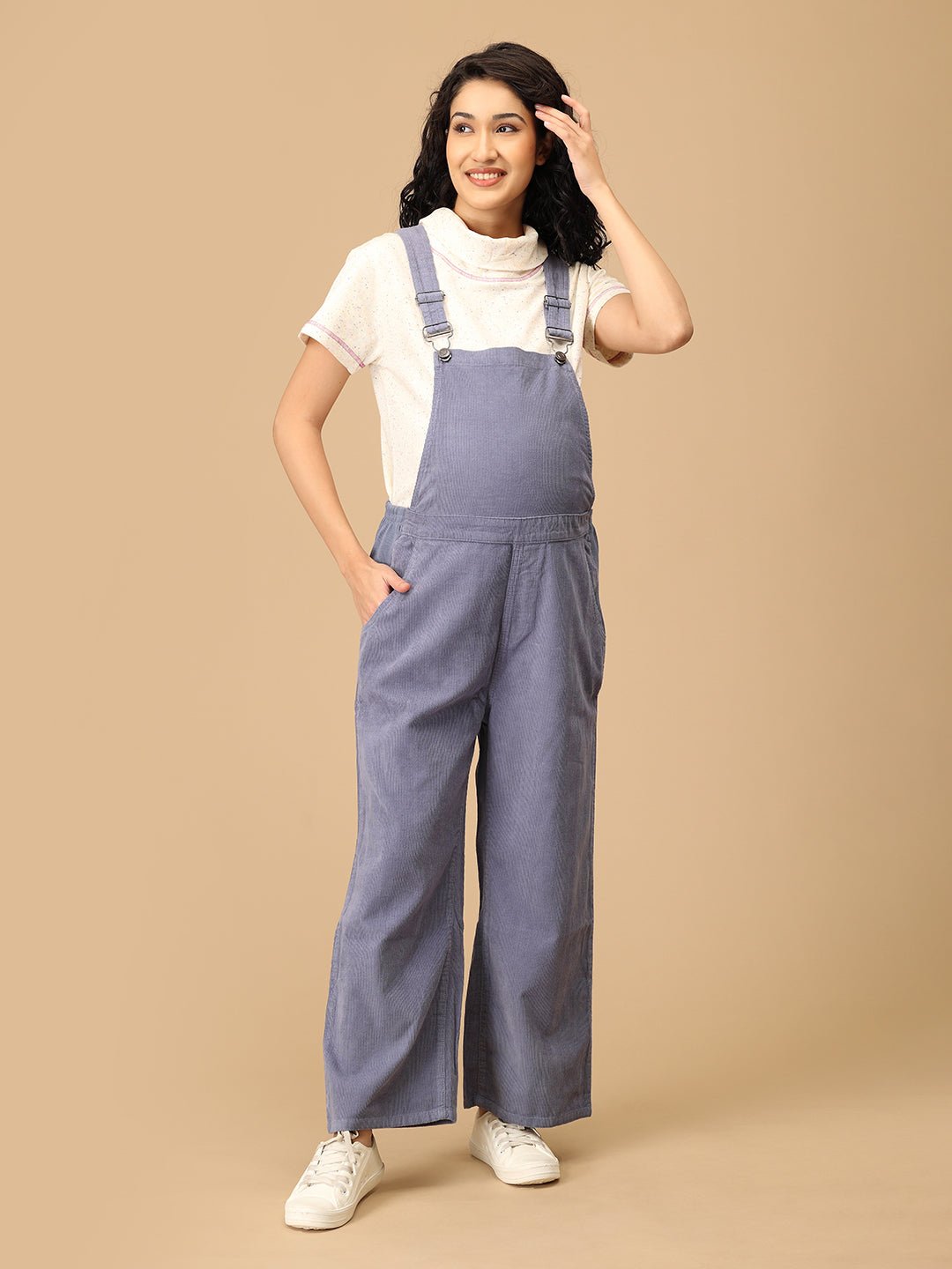 Front pose of pregnant woman in The Mom Store powder blue maternity dungaree with pockets.
