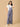 Front pose of pregnant woman in The Mom Store powder blue maternity dungaree with pockets.
