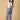 Smiling pregnant woman wearing The Mom Store powder blue corduroy maternity dungaree front pose.