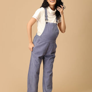 Smiling pregnant woman wearing The Mom Store powder blue corduroy maternity dungaree front pose.