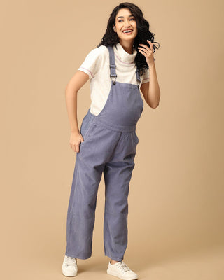 Smiling pregnant woman wearing The Mom Store powder blue corduroy maternity dungaree front pose.