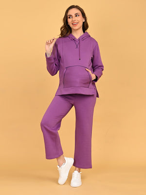 Pregnant model posing comfortably in Purple Frostbite maternity hoodie pajama loungewear set.