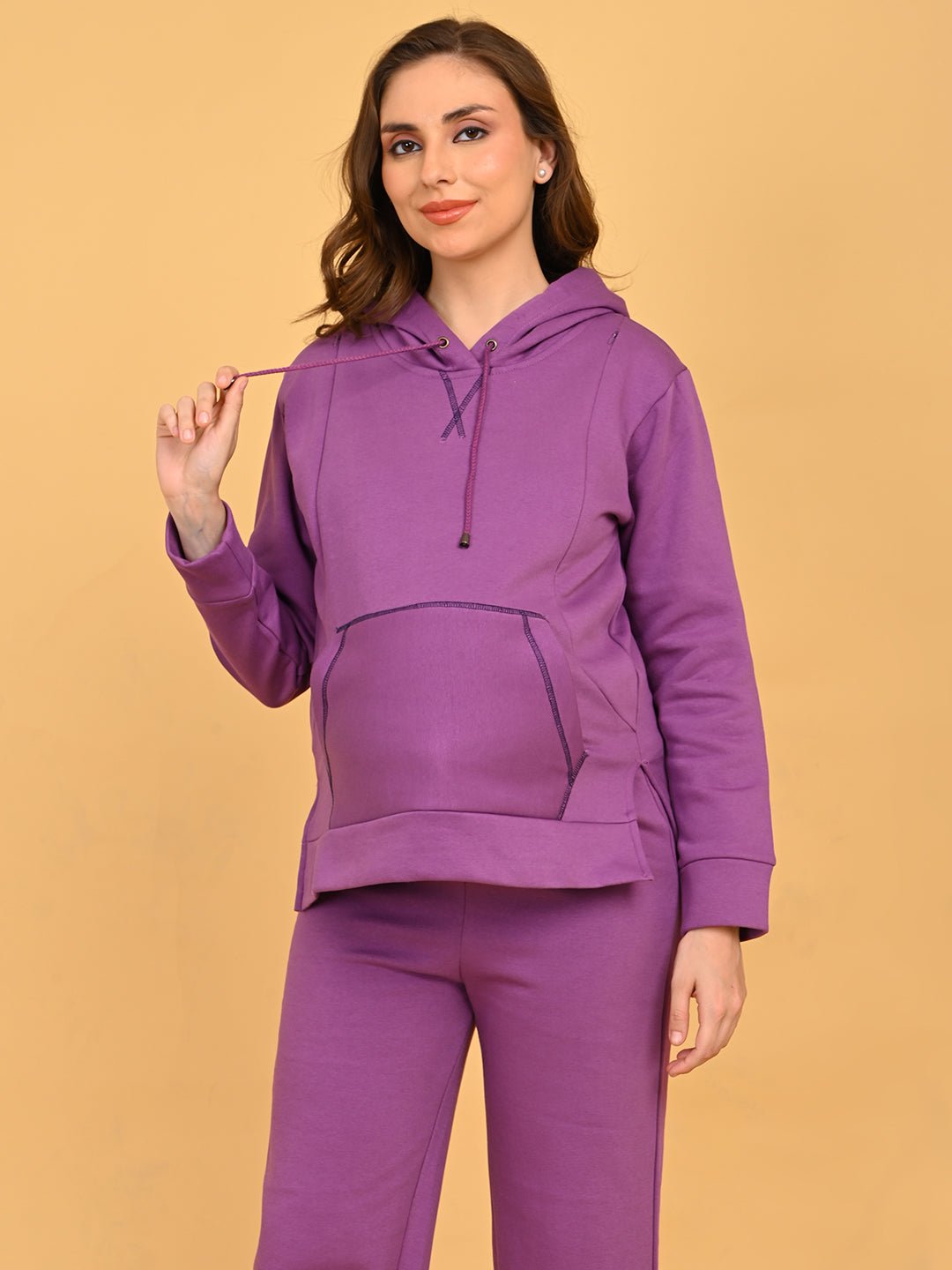 Model adjusting hood drawstring on Purple Frostbite maternity and nursing hoodie set.