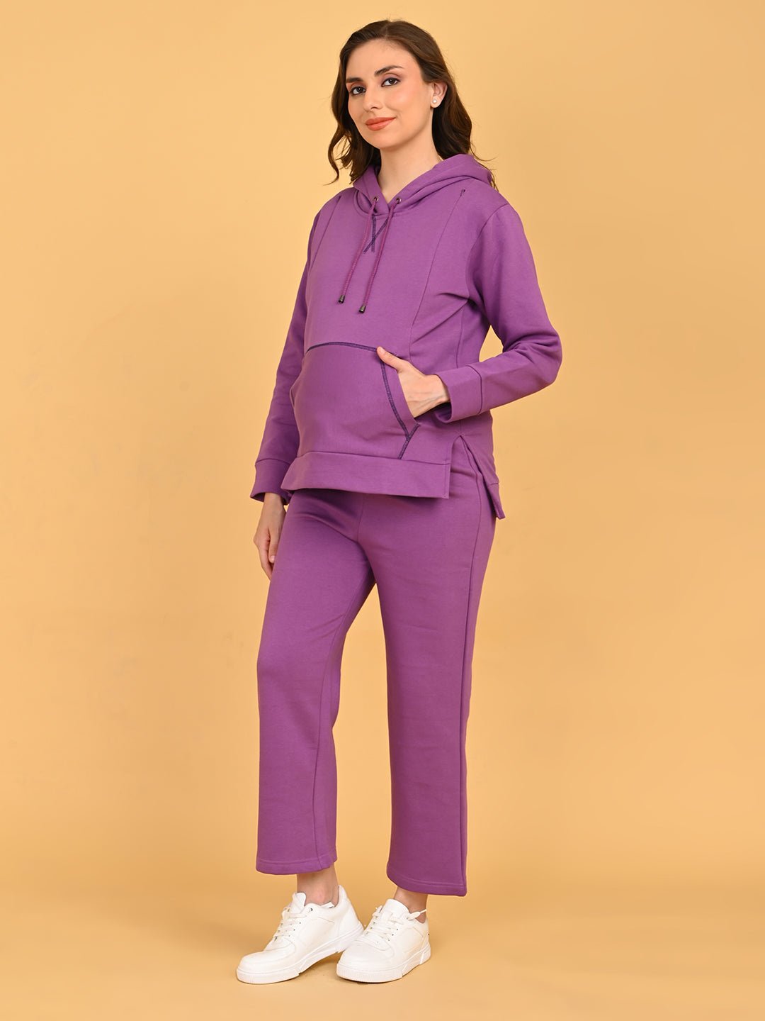Side view of pregnant model in Purple Frostbite nursing hoodie and lounge pants highlighting baby bump fit.