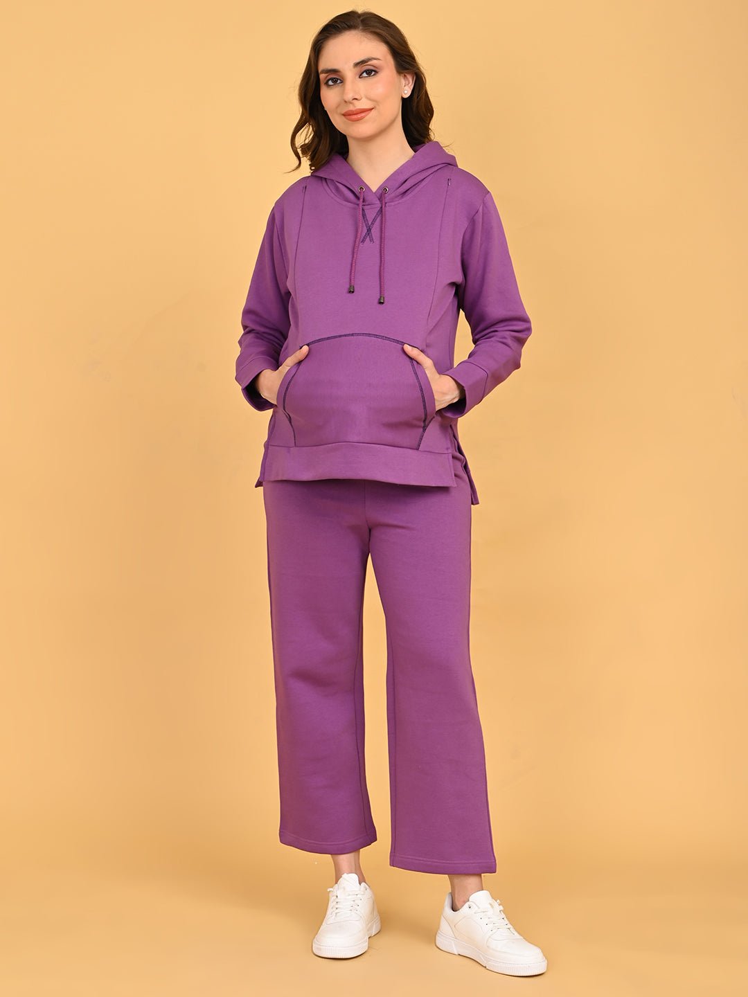 Pregnant model posing comfortably in Purple Frostbite maternity hoodie pajama loungewear set.