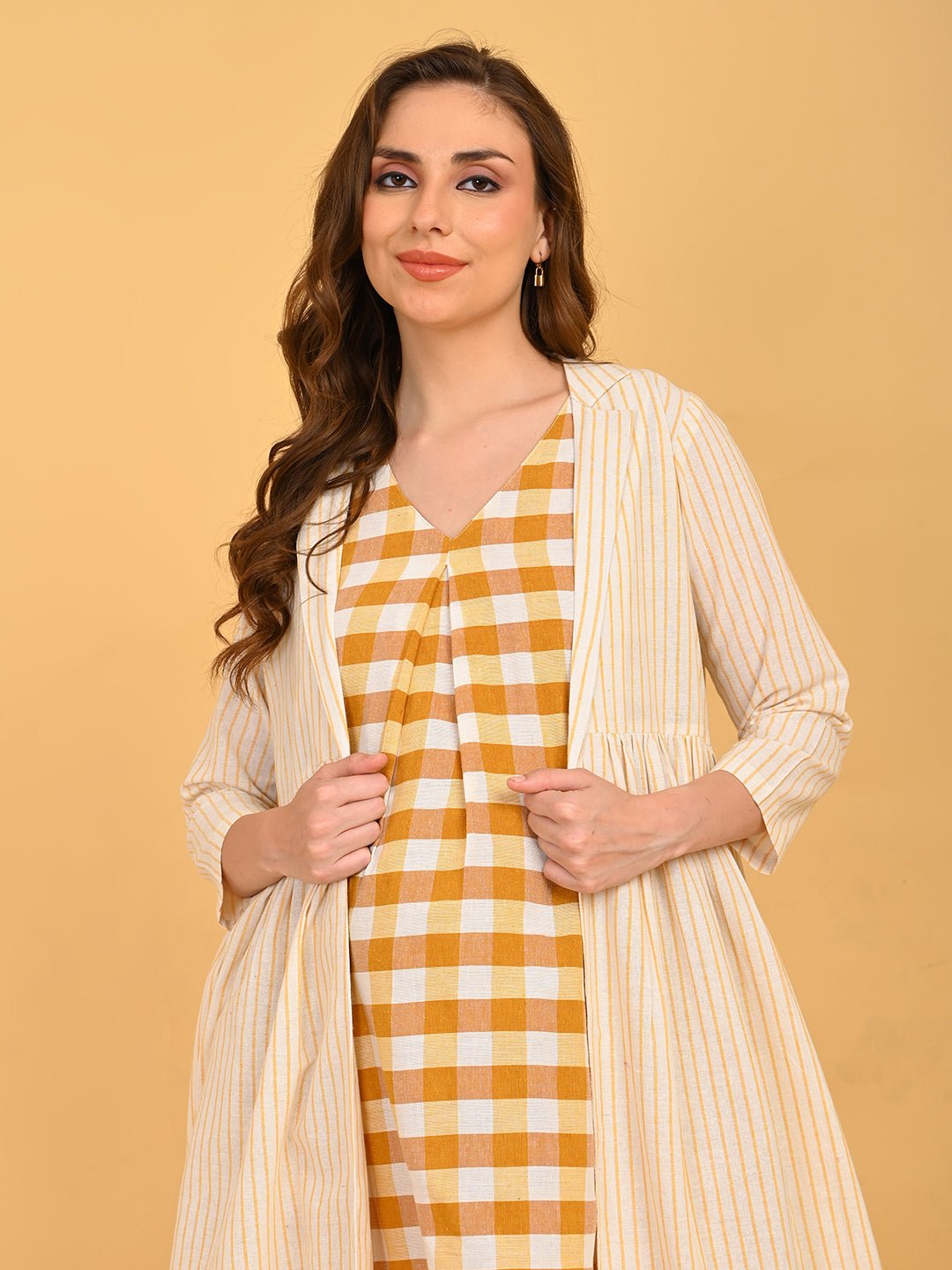 Quiet Grid Maternity and Nursing Shacket Dress front portrait of model wearing striped shacket over yellow check maternity dress.