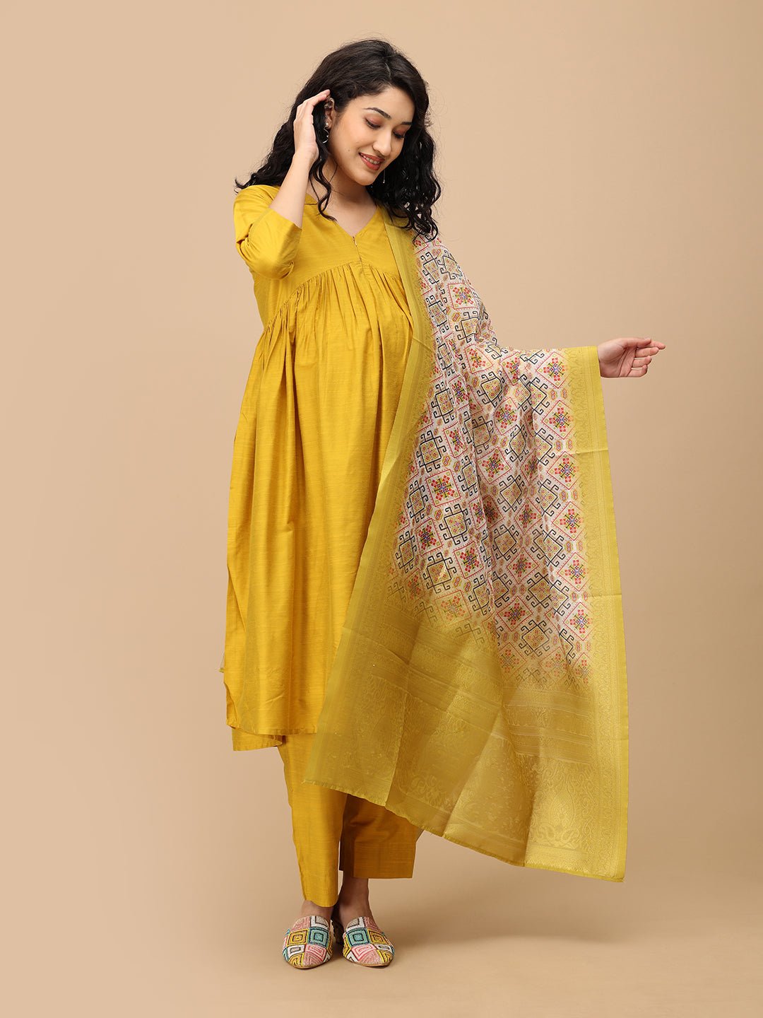 Side angle of The Mom Store mustard maternity silk kurta set with ornate yellow printed dupatta.