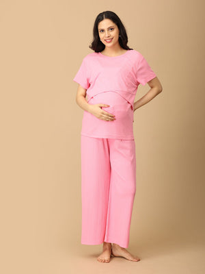 Playful pose by pregnant model wearing Ros√© All Day Maternity and Nursing Nightwear Set from the mom store, touching her belly