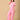 Playful pose by pregnant model wearing Ros√© All Day Maternity and Nursing Nightwear Set from the mom store, touching her neck