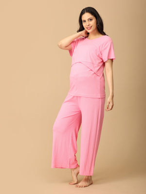 Playful pose by pregnant model wearing Ros√© All Day Maternity and Nursing Nightwear Set from the mom store, touching her neck