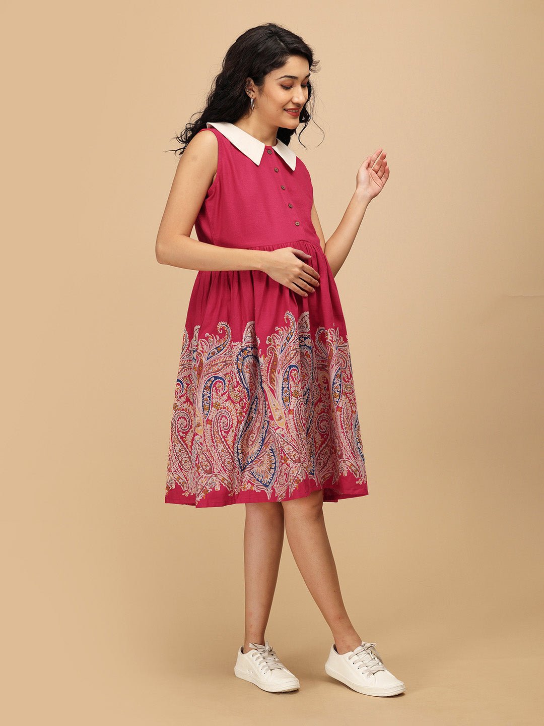 Model walking in the Rosé Lane Maternity and Nursing Dress, highlighting the flare, pink bodice, and multicolor paisley print.