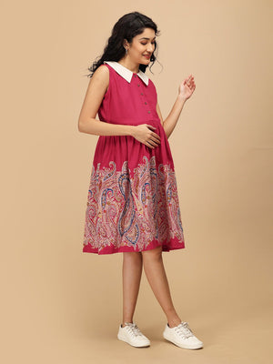 Model walking in the Ros√© Lane Maternity and Nursing Dress, highlighting the flare, pink bodice, and multicolor paisley print.