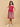 Side view of the Ros√© Lane Maternity and Nursing Dress with white collar and paisley border, model holding her baby bump.