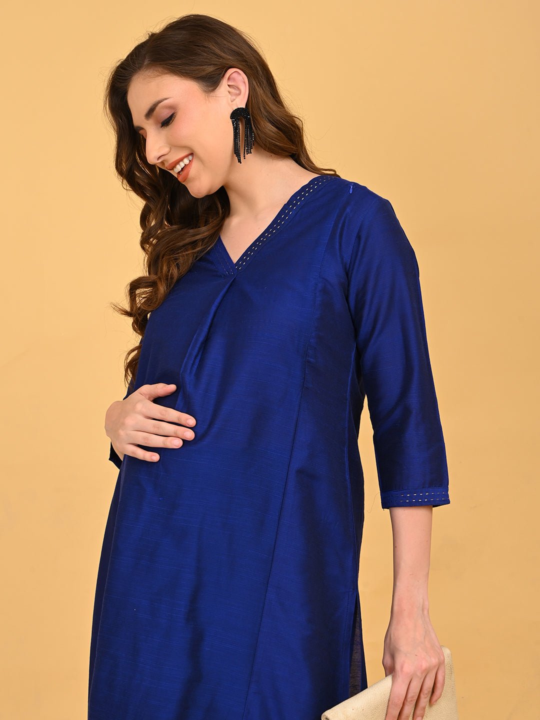 Close-up of V-neckline on royal blue maternity kurta with delicate embroidered stitch detailing.