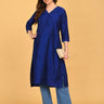 Pregnant model styling royal blue maternity kurta with light blue pants, white sneakers, and beige clutch.