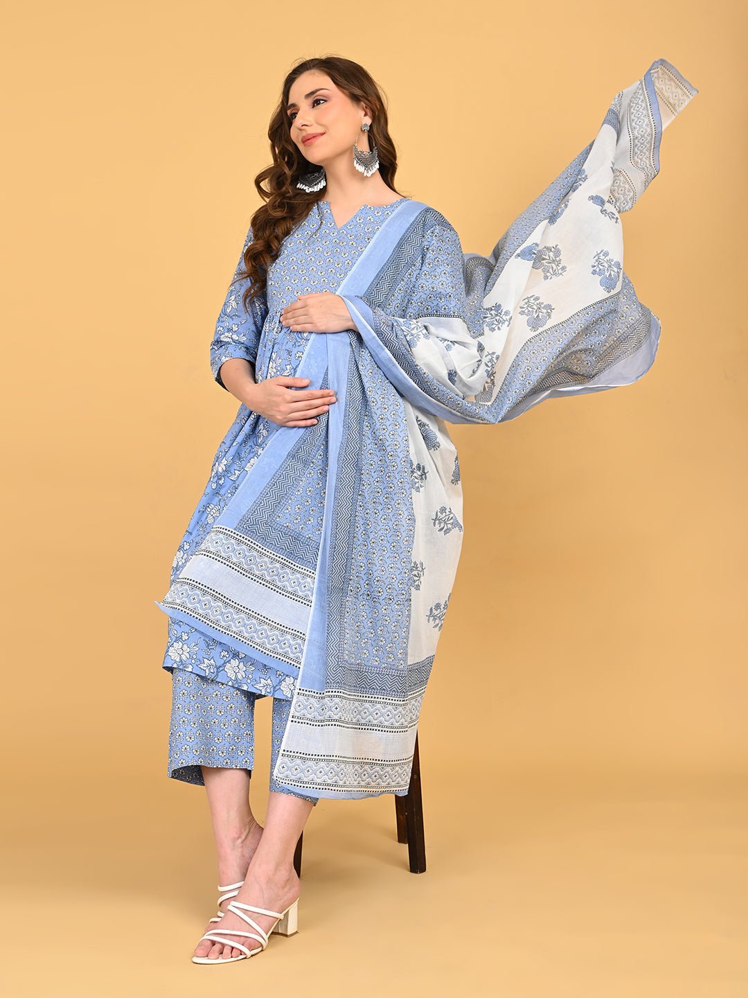 Model seated wearing ShyamAab Maternity and Nursing Kurta Set With Dupatta in blue floral print with matching bordered dupatta.