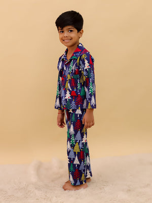 Side view of a smiling boy in The Mom Store Silent Night Christmas Pajama Set, highlighting the relaxed fit and soft cotton texture
