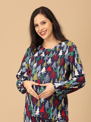 playful pose by Pregnant model touching her belly wearing Silent Night Maternity Pajama Set from the mom store