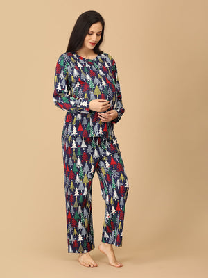 playful pose by Pregnant model touching her belly wearing Silent Night Maternity Pajama Set from the mom store