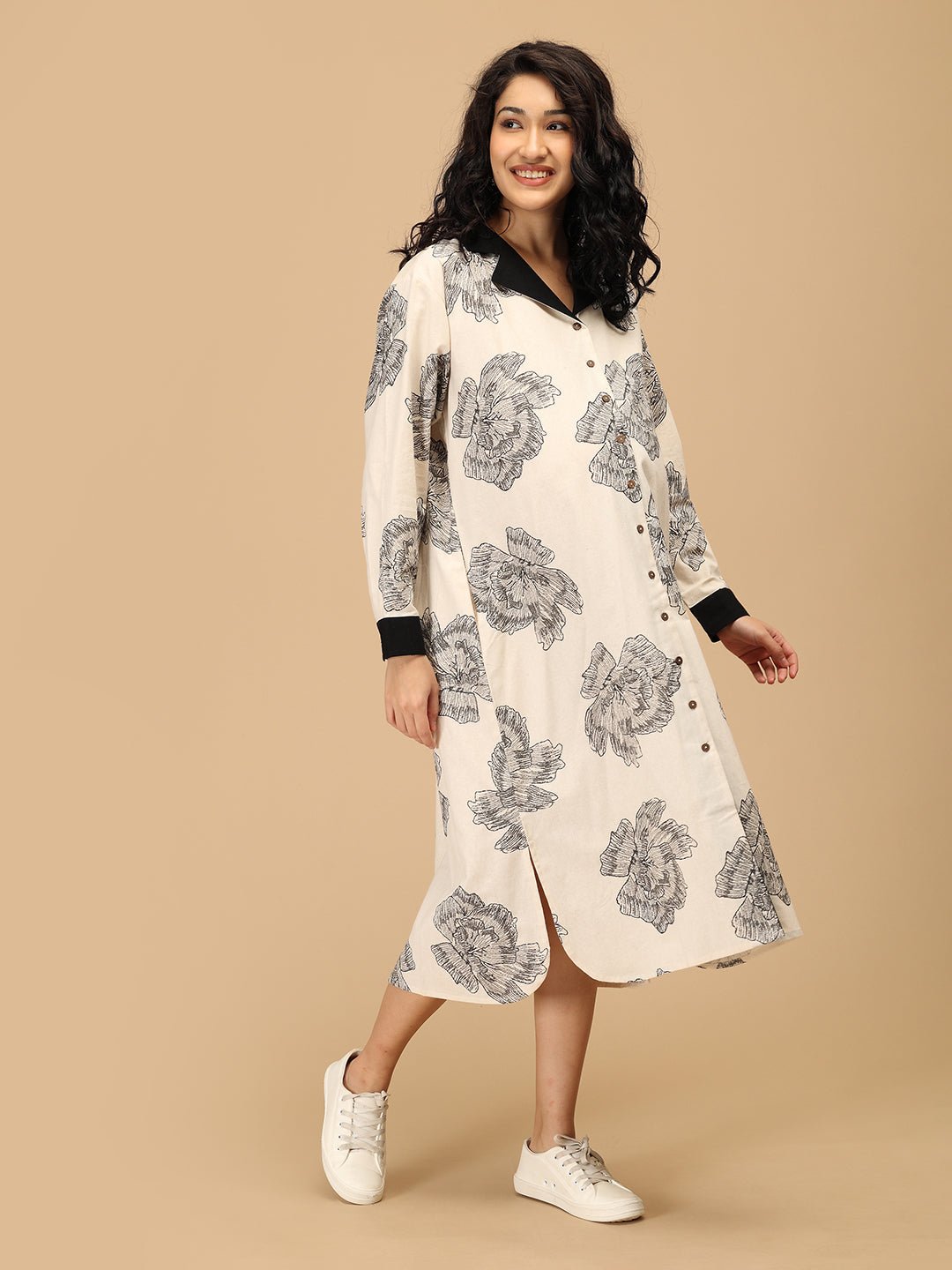 Pregnant woman in The Mom Store Sketch Petal maternity and nursing dress with black floral print.