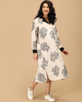 Pregnant woman in The Mom Store Sketch Petal maternity and nursing dress with black floral print.