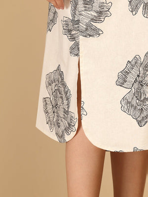 Close-up of side slit detail on The Mom Store Sketch Petal maternity dress with floral sketch print.