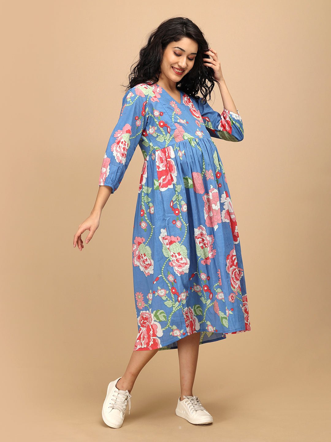 Twirling pose in The Mom Store Sky Bloom maternity and nursing dress with pink floral prints.