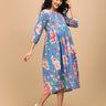 Twirling pose in The Mom Store Sky Bloom maternity and nursing dress with pink floral prints.