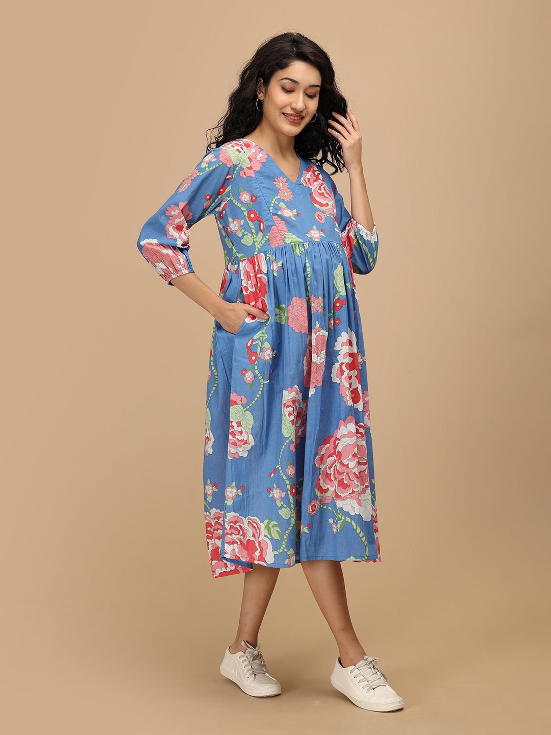 Side pose of The Mom Store Sky Bloom maternity dress with pockets and vibrant floral design.