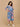 Side pose of The Mom Store Sky Bloom maternity dress with pockets and vibrant floral design.
