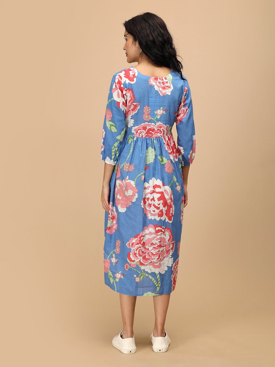 Back view of The Mom Store Sky Bloom blue maternity dress featuring bold floral patterns.