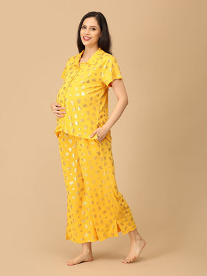 Pregnant model wearing yellow Sparkle Season Maternity and Nursing Nightwear Set from the Mom Store turned sideways touching her belly