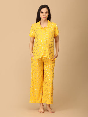 Pregnant model wearing yellow Sparkle Season Maternity and Nursing Nightwear Set from the Mom Store