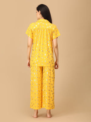 Pregnant model wearing yellow Sparkle Season Maternity and Nursing Nightwear Set from the Mom Store turned backwards