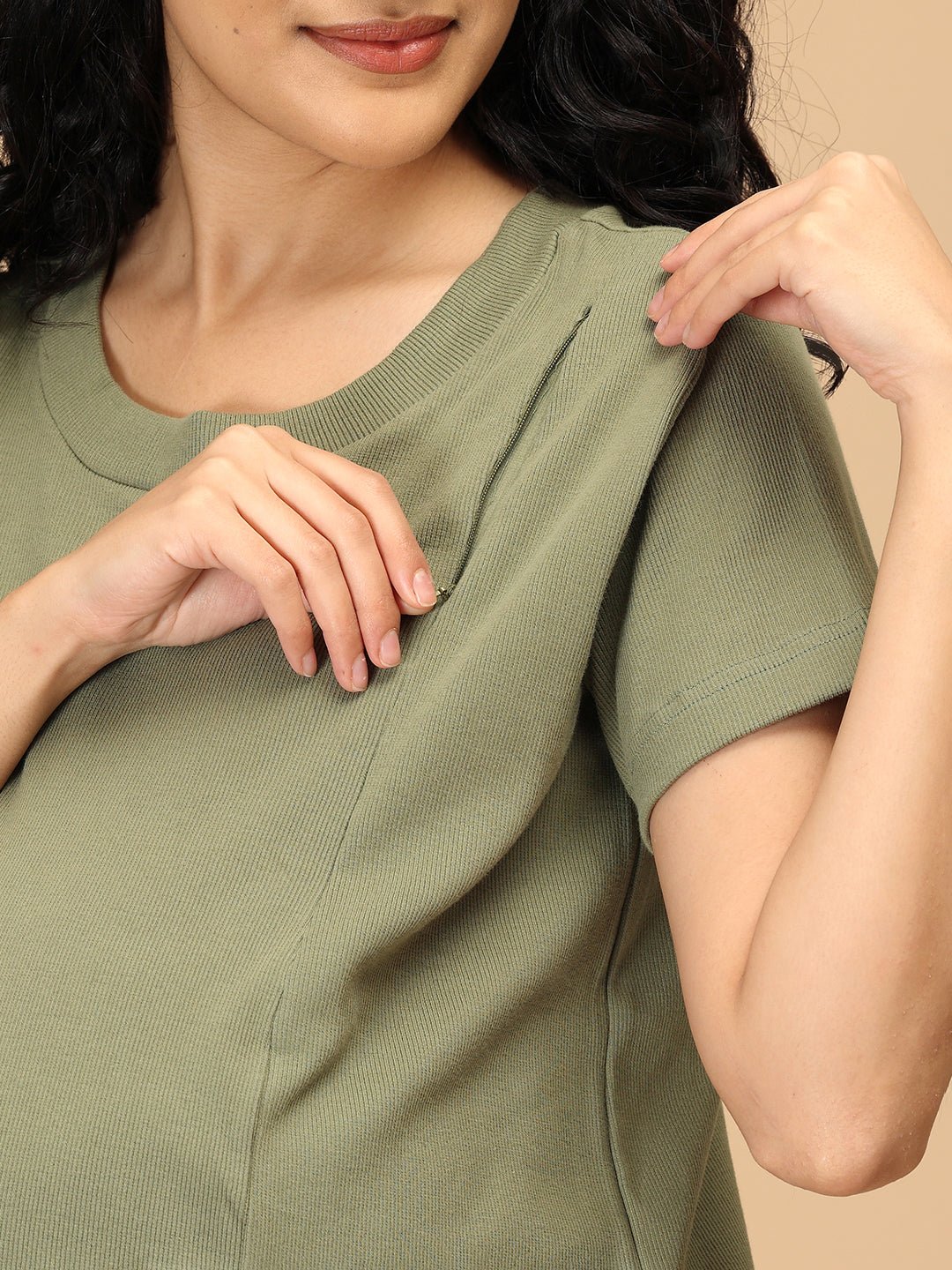 Close-up of concealed vertical nursing zipper on green ribbed maternity nightwear top