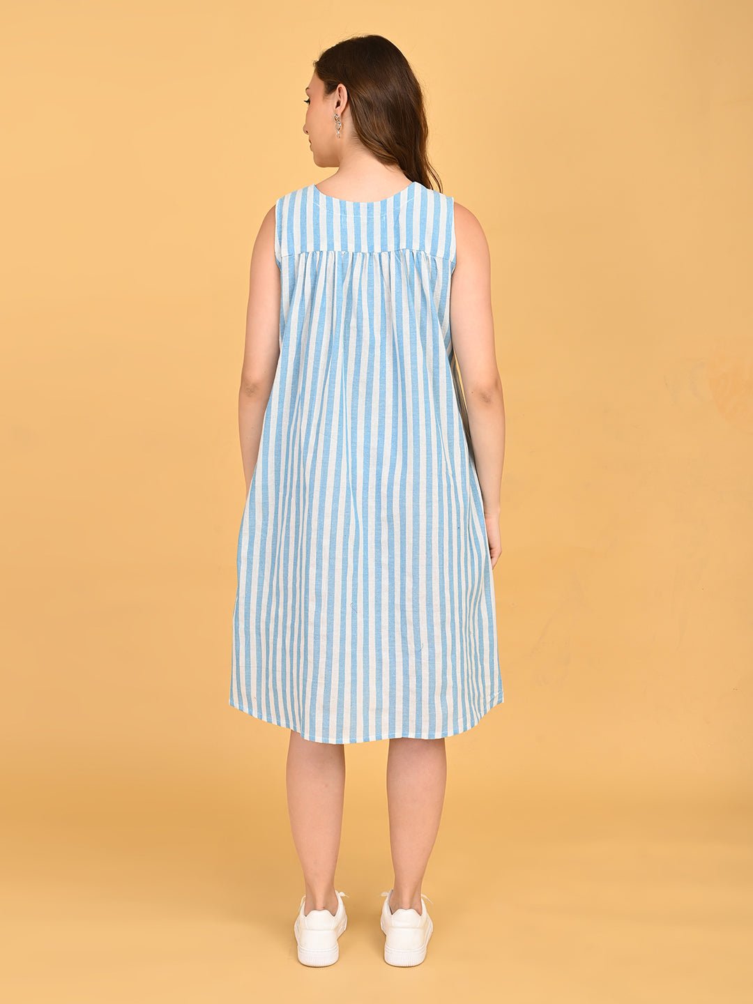 Back view of blue and white striped sleeveless maternity dress with relaxed gathered silhouette.