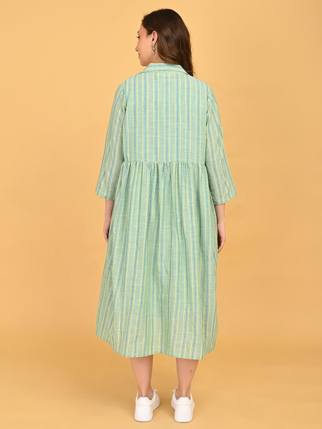 Back view of green striped long maternity shacket with gathered waist detail and three-quarter sleeves.