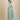 Side pose maternity and nursing outfit with green striped longline shacket over striped maxi dress.