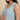 Close-up of blue white striped sleeveless nursing maxi dress with V-neckline and soft fabric texture.