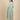 Back view of green striped maternity shacket with gathered waist, layered over striped nursing dress.