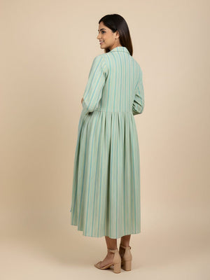 Back view of green striped maternity shacket with gathered waist, layered over striped nursing dress.
